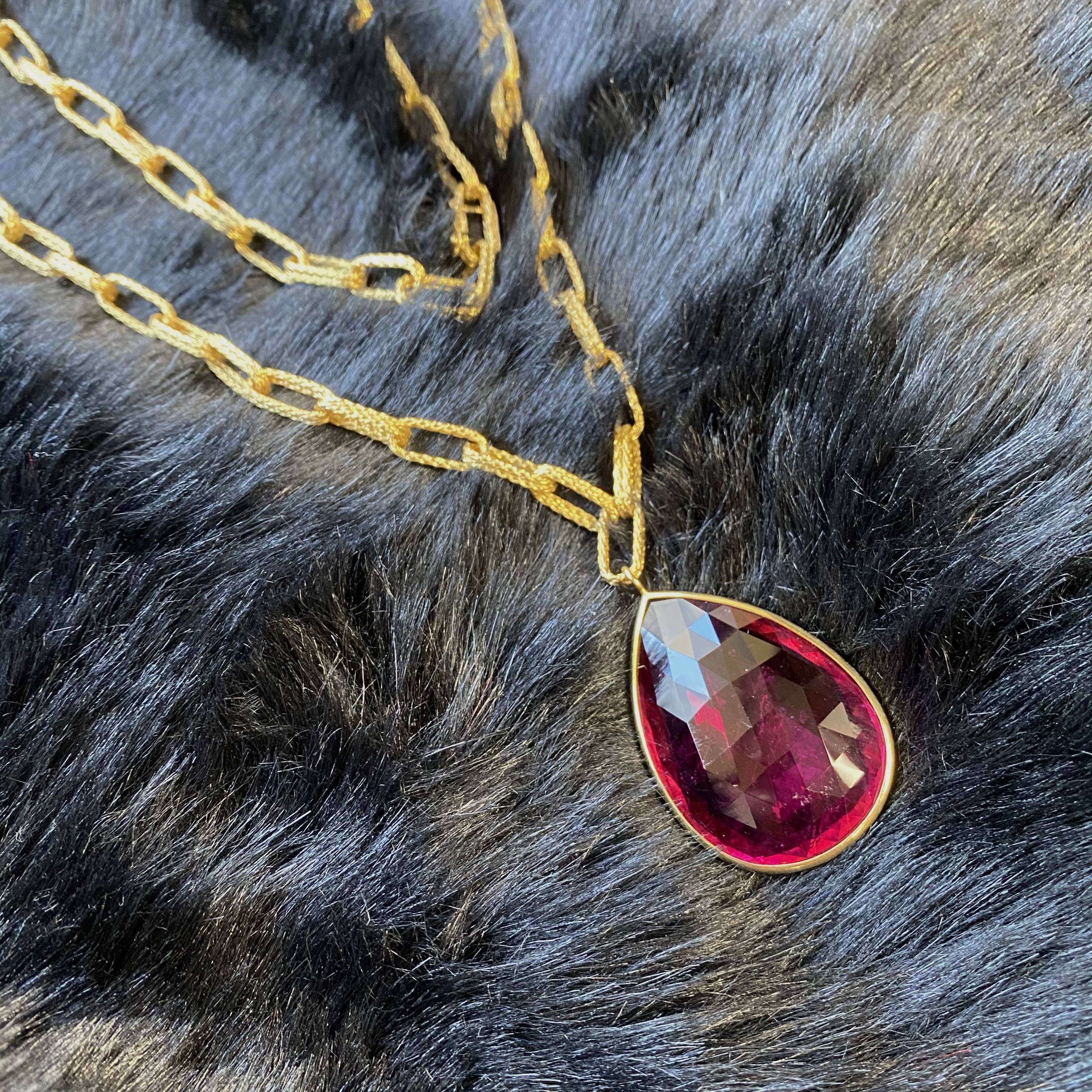 Rubellite pendant with a large texture solid 18 karat gold chain by fine jewelry designer Goshwara