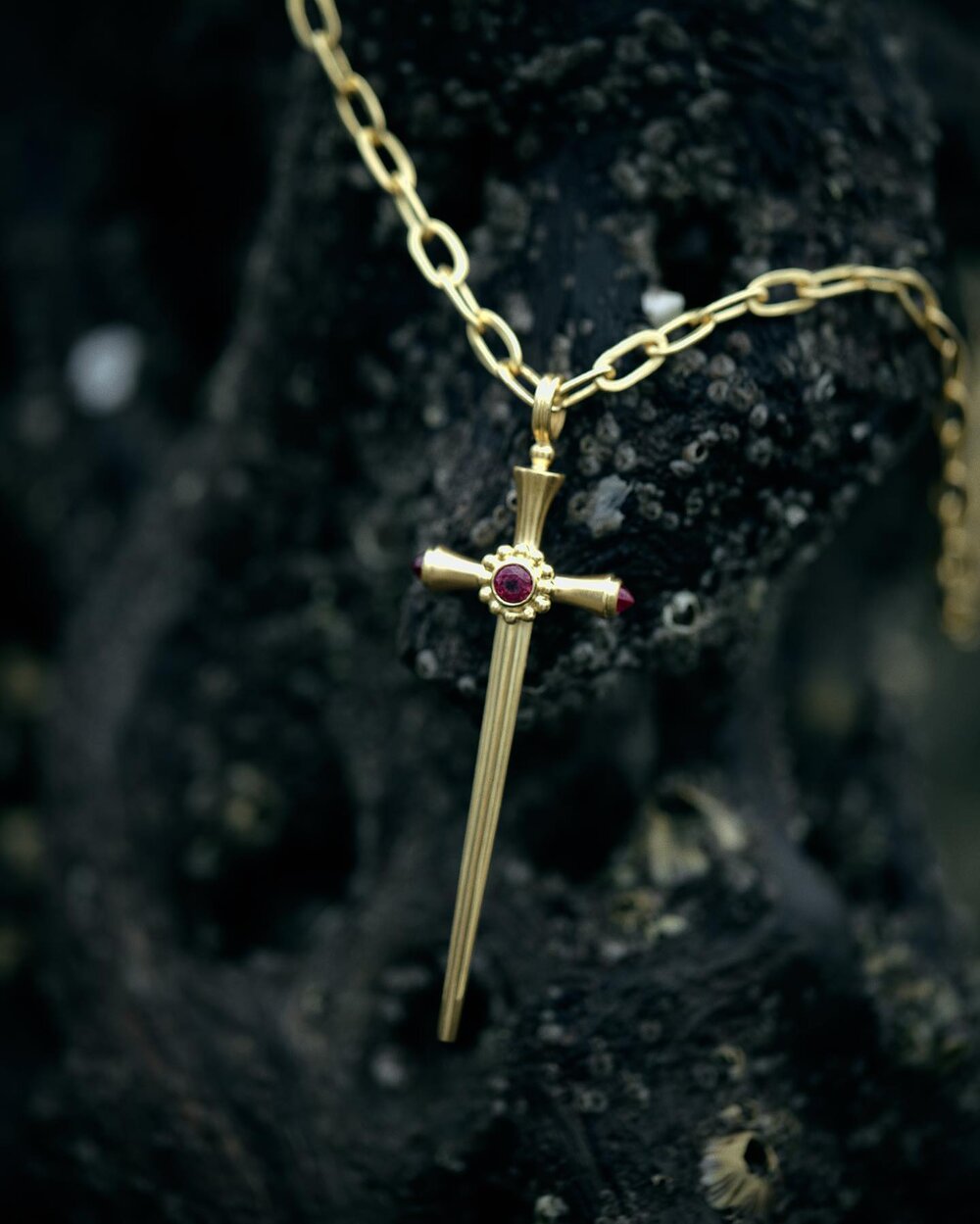 Gold ruby sword pendant by fine jewelry designer Linda Hoj