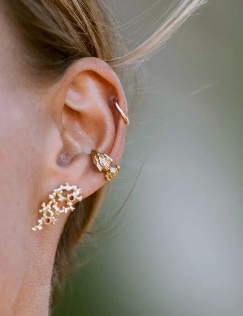 Gold and garnet earrings by jewelry designer Clio Saskia.